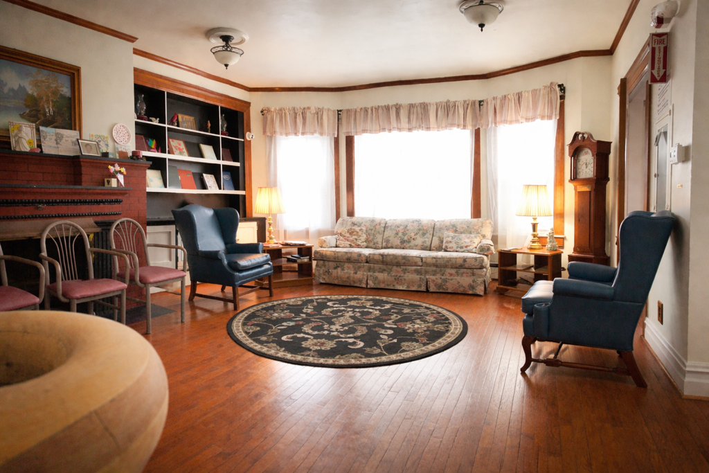 The library at Hearthstone Retirement Home with bookshelves and reading chairs